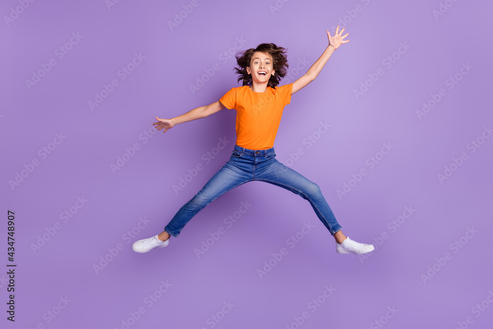 Full length body size view of attractive funky cheerful boy jumping fooling isolated over violet purple color background