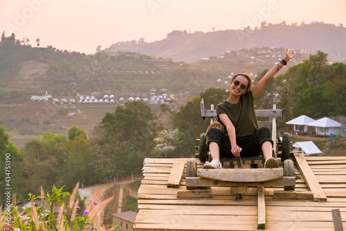 Young women sitting on wooden car and having enjoy moment , freedom and recreation concept
