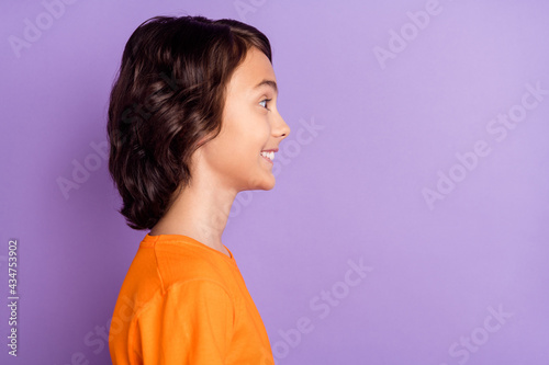 Profile side view portrait of attractive funny cheerful boy copy empty space isolated over violet purple color background