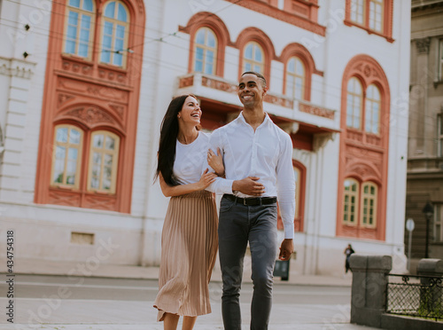 Wallpaper Mural Young multiethnic couple walking on the street Torontodigital.ca