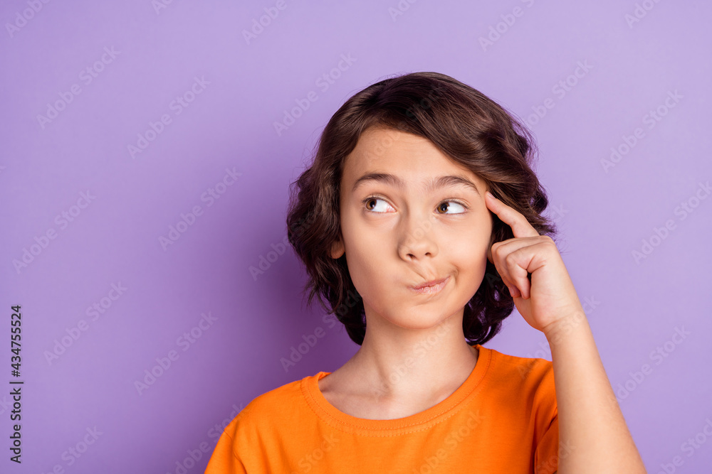 Portrait of nice unsure bewildered boy touching temple overthinking smirk isolated over violet purple color background Portrait of nice unsure bewildered boy touching temple overthinking smirk isolated over violet purple color background