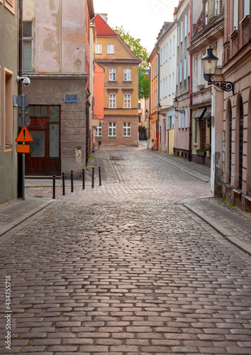 Poznan. Old traditional narrow city street at sunrise.