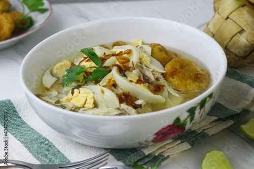 Soto Banjar, Indonesian traditional cuisine from South Kalimantan. The ingredients include ketupat, egg, chicken slices. Served with sambal and lime. Served on Idul adha and Idul Fitri celebration.