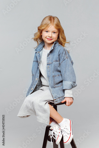 portrait of a little fashionable girl in the studio