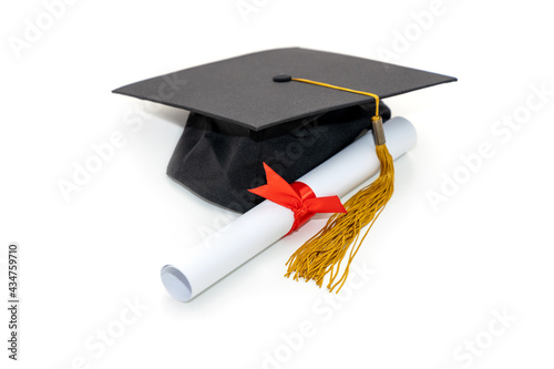 Front view of graduation hat and diploma, isolated on white background. Education concept. photo