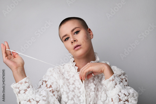Beautiful young bald woman, posing in the studio. Isolated. photo