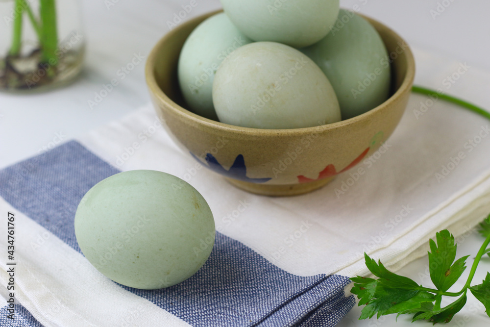 Telur bebek rebus or boiled duck eggs on ceramic bowl. White background, copy space for text. Telur bebek rebus or boiled duck eggs on ceramic bowl. White background, copy space for text.