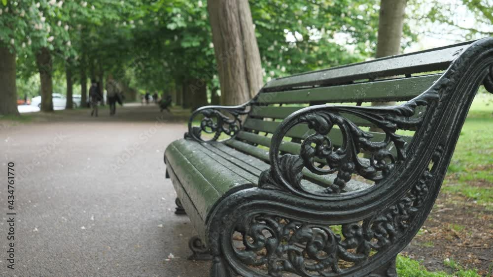 A close up view of an empty bench in a park.