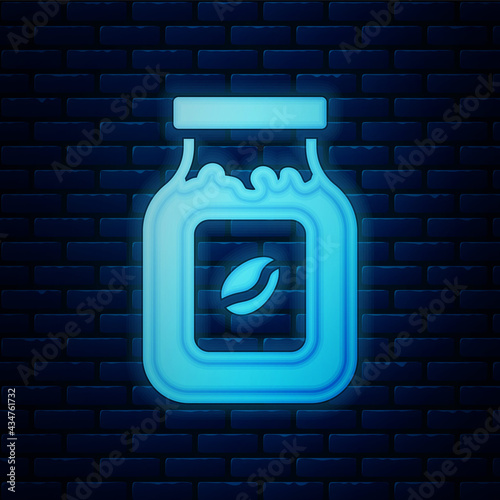 Glowing neon Coffee jar bottle icon isolated on brick wall background. Vector