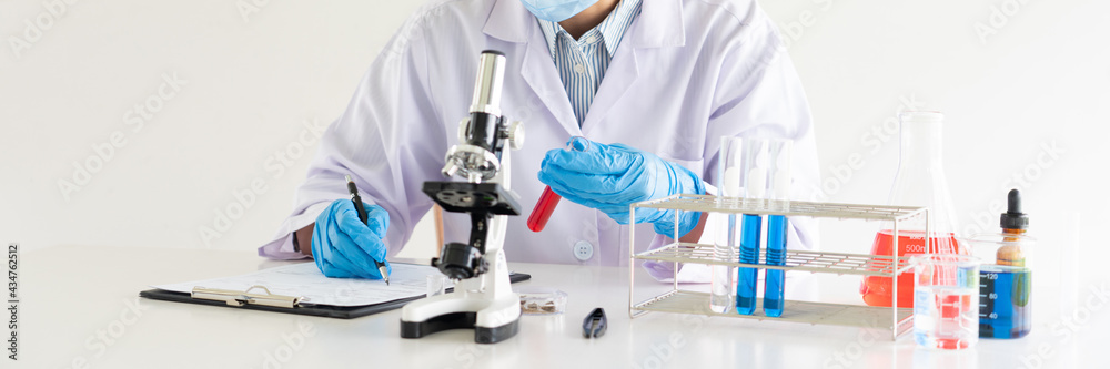 scientists researching in laboratory in white lab coat, gloves analysing, looking at test tubes sample, biotechnology concept scientists researching in laboratory in white lab coat, gloves analysing, looking at test tubes sample, biotechnology concept