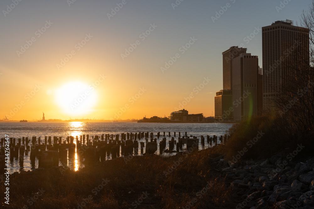 Beautiful New York City Sunset along the East River seen From the Shore of Brooklyn Heights in Silhouette