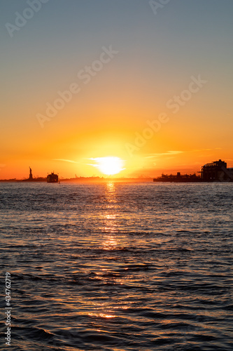 Beautiful New York City Sunset along the East River and Hudson River with the Statue of Liberty