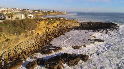 Aerial view of waves, hitting the coast of Lisbon - reverse, drone shot