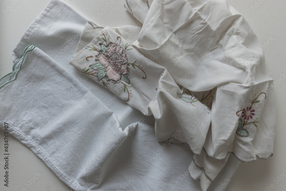cotton fabric linens (pillow case and doily) - photographed from above with ambient light cotton fabric linens (pillow case and doily) - photographed from above with ambient light
