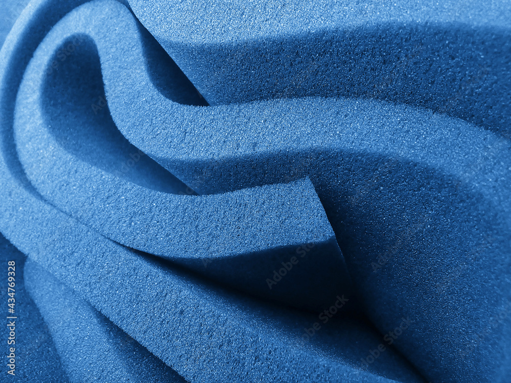 rolled up blue foam sponge. foam sponge rubber texture sheet. folds of
