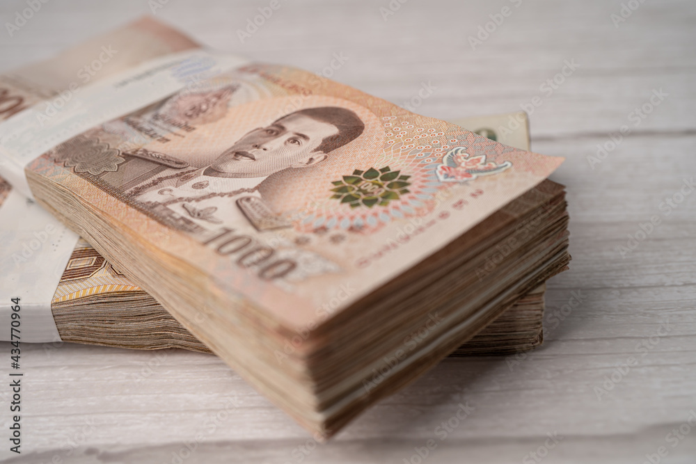 Stack of Thai baht banknotes on wooden background, business saving finance investment concept. Stack of Thai baht banknotes on wooden background, business saving finance investment concept.