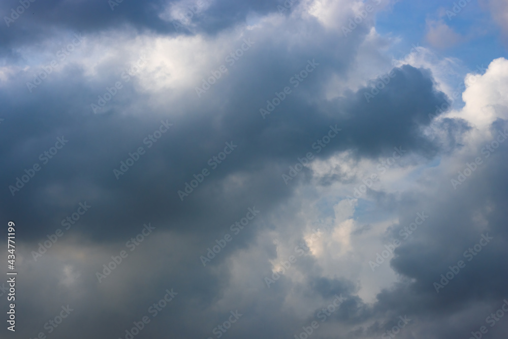 Dark blue cloud moving under the blue sunny sky Dark blue cloud moving under the blue sunny sky