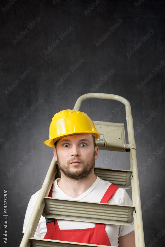 Portrait of a clumsy worker with ladder - obrazy, fototapety, plakaty 