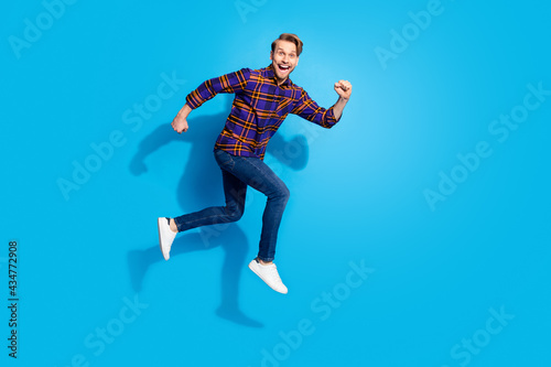 Full body profile portrait of carefree crazy man open mouth look camera isolated on blue color background
