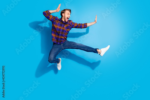 Full size photo of excited person open mouth look empty space fighting isolated on blue color background