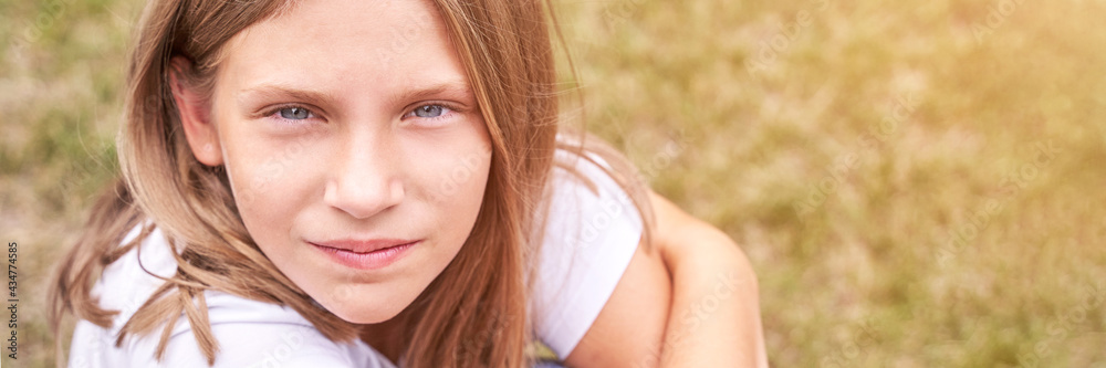 Little girl portrait. Outdoor green background. Looking. Teenager schoolgirl at park. Cute face. Children beauty. Female head. Charisma caucasian Little girl portrait. Outdoor green background. Looking. Teenager schoolgirl at park. Cute face. Children beauty. Female head. Charisma caucasian