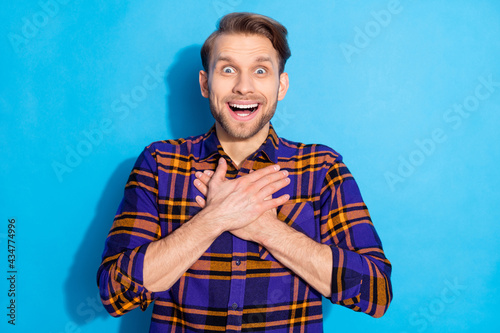 Portrait of attractive impressed cheerful man great news gift reaction isolated over bright blue color background