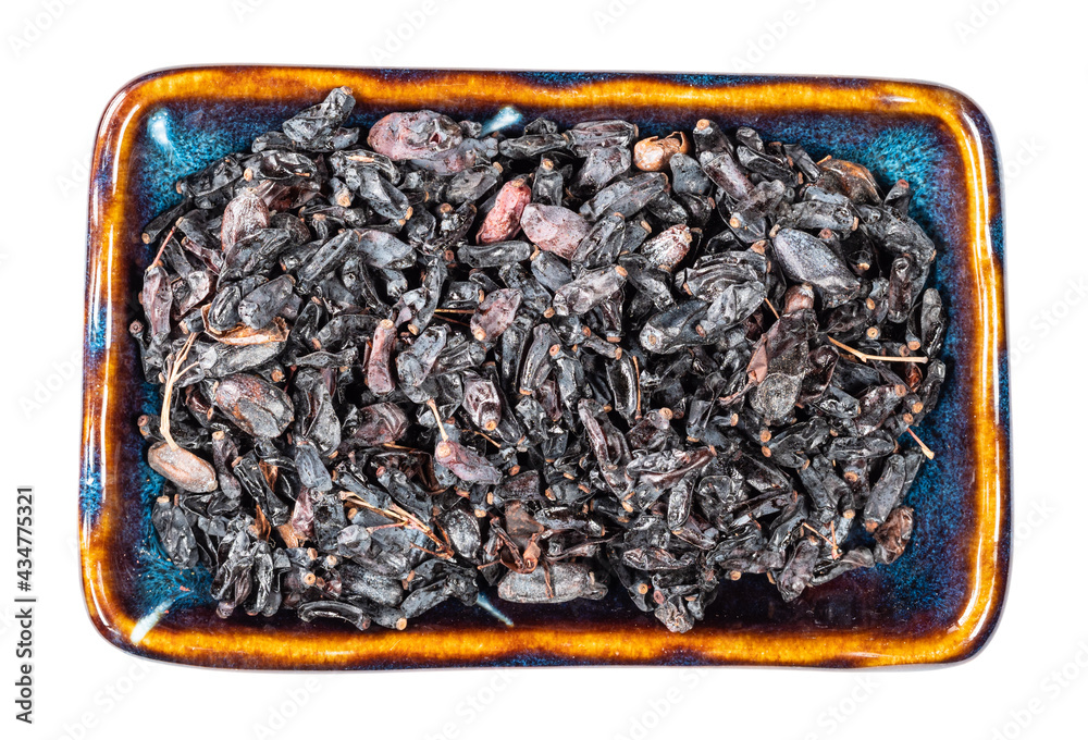 dried black Berberis fruits in ceramic bowl cutout dried black Berberis fruits in ceramic bowl cutout
