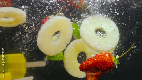 Fruit lemonade, fruits immersed in water.