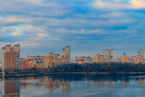 View of Obolon embankment of the Dnieper river and church of the Nativity of Christ in Kiev, Ukraine © olyasolodenko