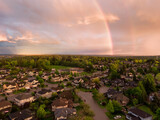 Aerial view of a suburban neighborhood during a vibrant and colorful sunset. Taken in Greater Vancouver, British Columbia, Canada.