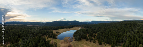 Aerial Panoramic View of a Lake in the Canadian Landscape. Cloudy and Sunny Spring Sunset. Taken near Kamloops and Merritt, British Columbia, Canada.