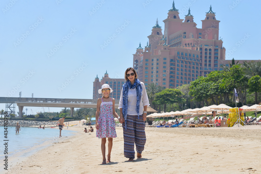 happy mother with daughter posing on beach happy mother with daughter posing on beach