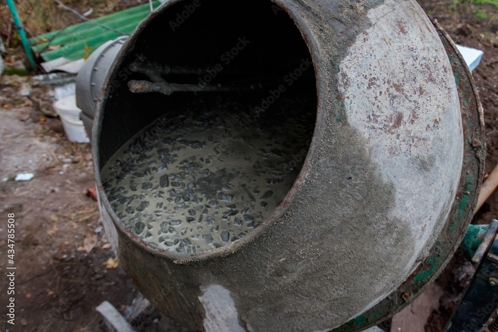 Mixing of concrete in the concrete mixer at construction site Mixing of concrete in the concrete mixer at construction site