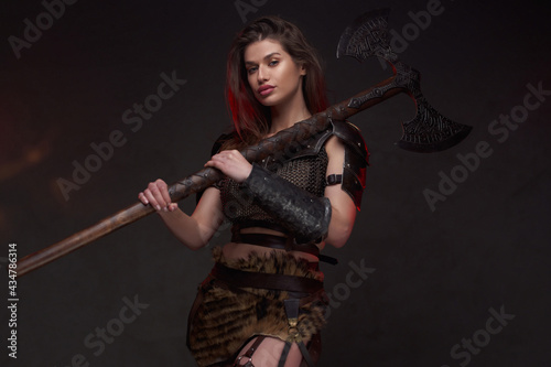 Nordic female fighter with long brown hairs and axe