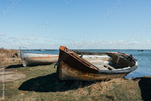 Old forgotten rusty boat on Baltic seashore on Baltic spit