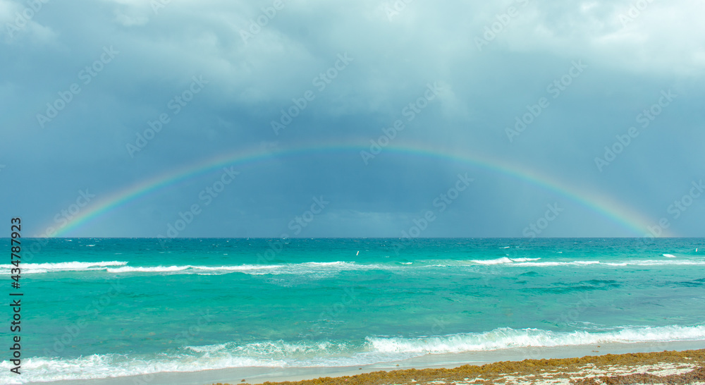 Rainbow on a cloudy day at the beach Rainbow on a cloudy day at the beach