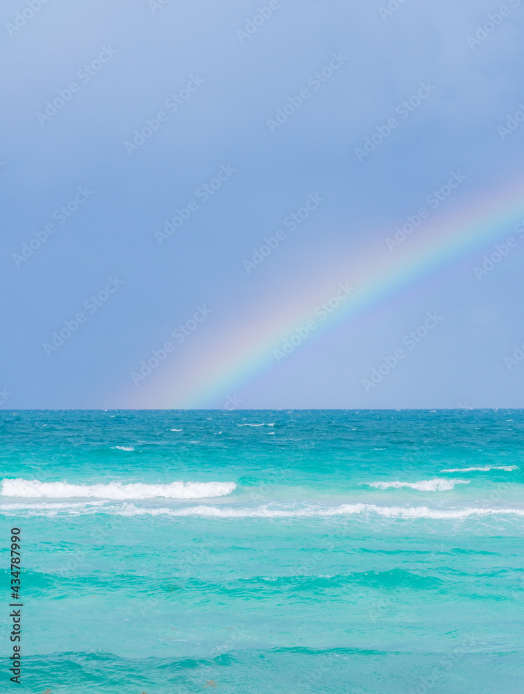 Rainbow on a cloudy day at the beach Rainbow on a cloudy day at the beach