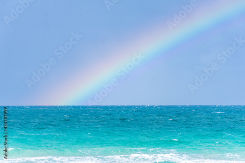 Rainbow on a cloudy day at the beach