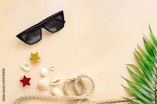 summer background bright color concept lemonade or juice drink, sun glasses, shells, cocktail straws sea nautical theme on the table healthy food meal snack copy space food background rustic. top view