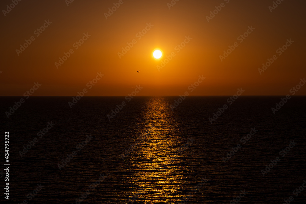 Amazing sunset on the sea horizon with clear sky without clouds