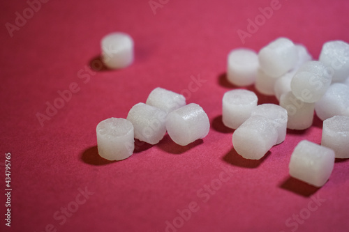 close up of camphor pill on red background. camphor isolated view. use for clean environment, healthcare, worship, praying. To make the environment cleaner. To cure illness.
