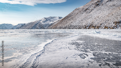 The ice of Lake Baikal near the rocky shores