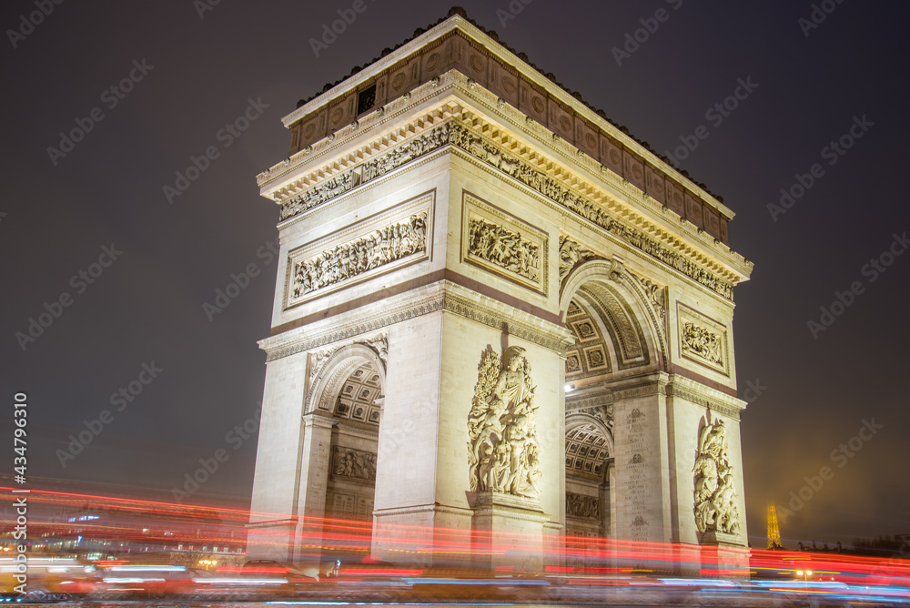 Fototapeta premium Paris, France - February 3, 2017: Paris Arc de Triomphe long exposure with traffic lights. Majestic Structure