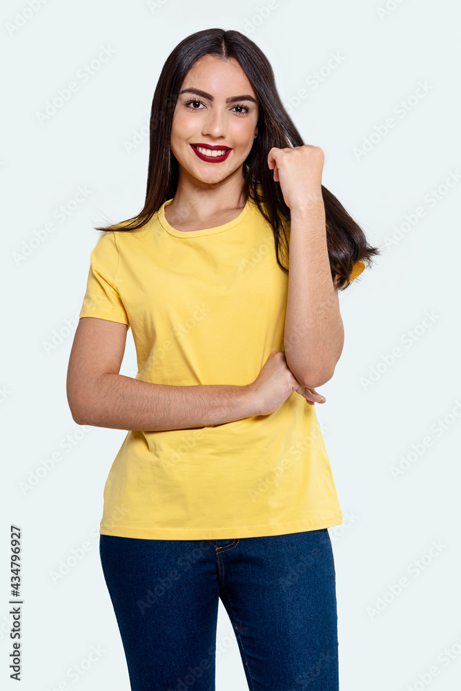 Studio photography of Brazilian woman in elegant yellow blouse and smiling, isolated on white background. Beautiful female model with white background Studio photography of Brazilian woman in elegant yellow blouse and smiling, isolated on white background. Beautiful female model with white background