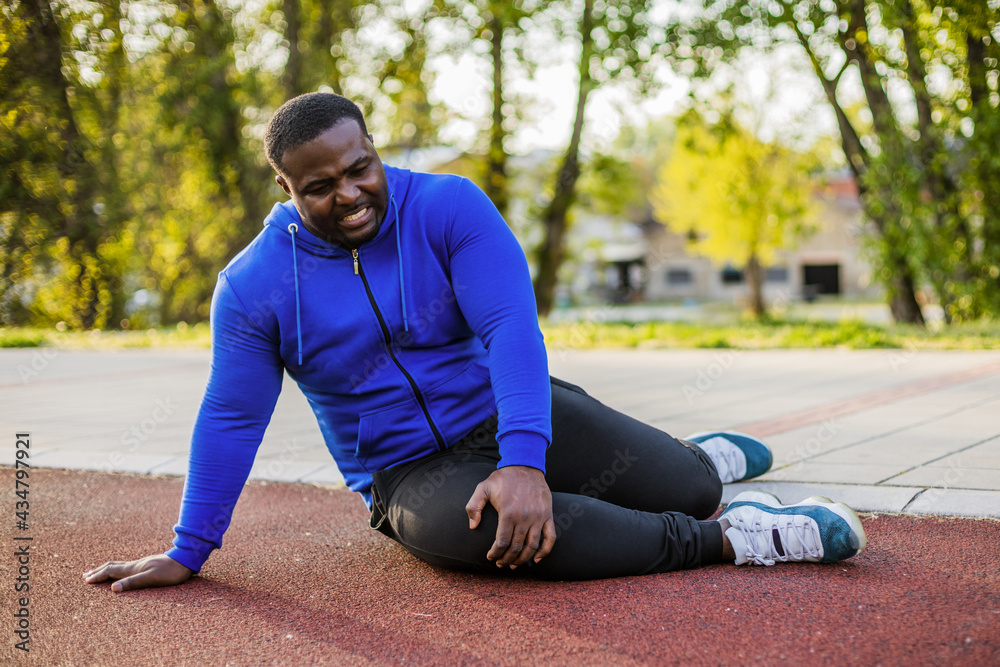 Man has got sport injury from exercising. Man has got sport injury from exercising.
