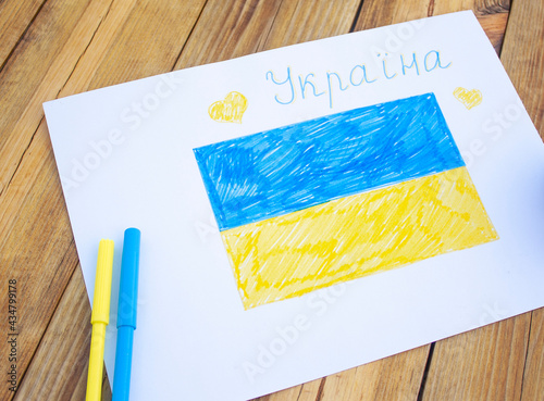 drawn on paper ukrainian flag and the word Ukraine in ukrainian photo