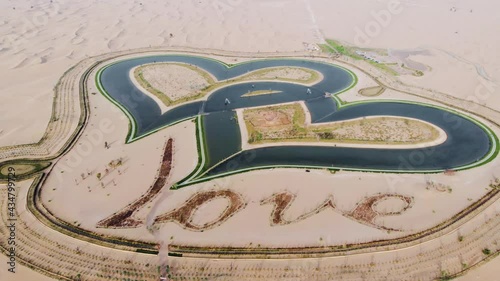 Heart shape Love lake in Dubai desert in Al Qudra area aerial view photo