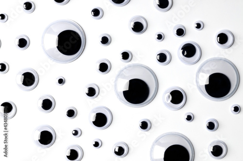 Top view of many shaky plastic doll eyes on white background. photo
