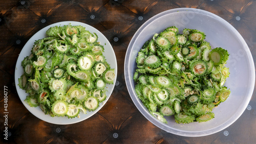 Green Chopped Bitter Gourd on two Plastic Pots top view