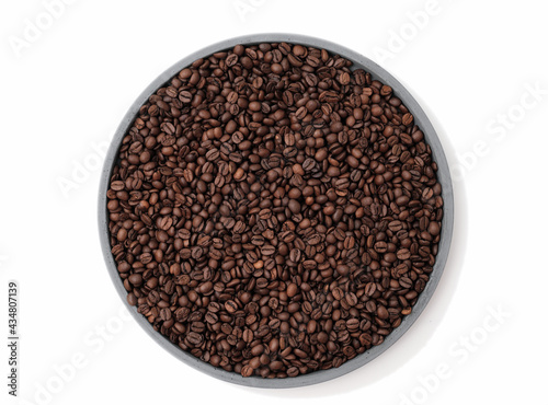 roasted coffee beans on a cement tray on white backgound. isolated coffee beans on a plate